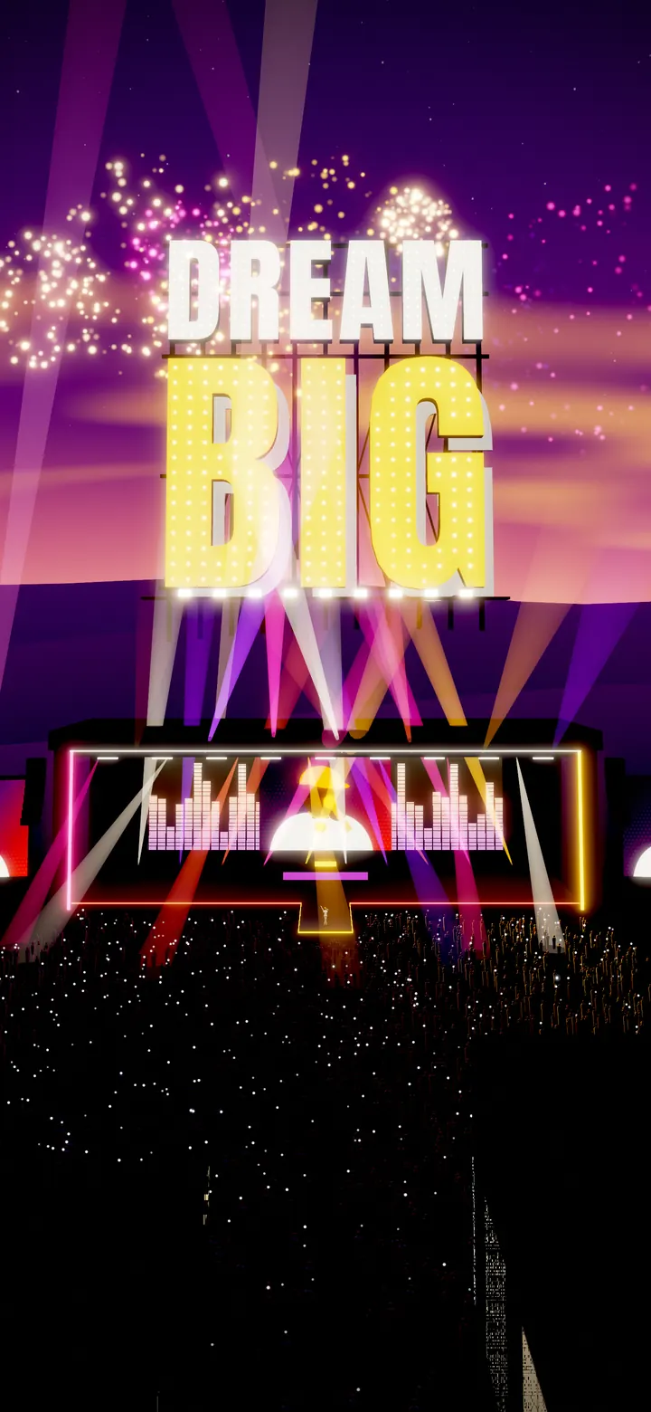 The lit DREAM BIG sign standing directly above the main stage, with the crowd's phone lights below.